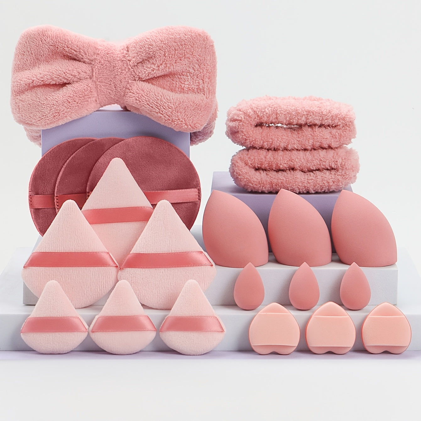 A Set of 21 Hair Accessories, Including 1 Butterfly Headband, 2 Wristbands, 6 Powder Puffs, 3 Makeup Sponges, 3 Finger Cushions, 3 Makeup Remover Pads, And 3 Mini Beauty Sponges.