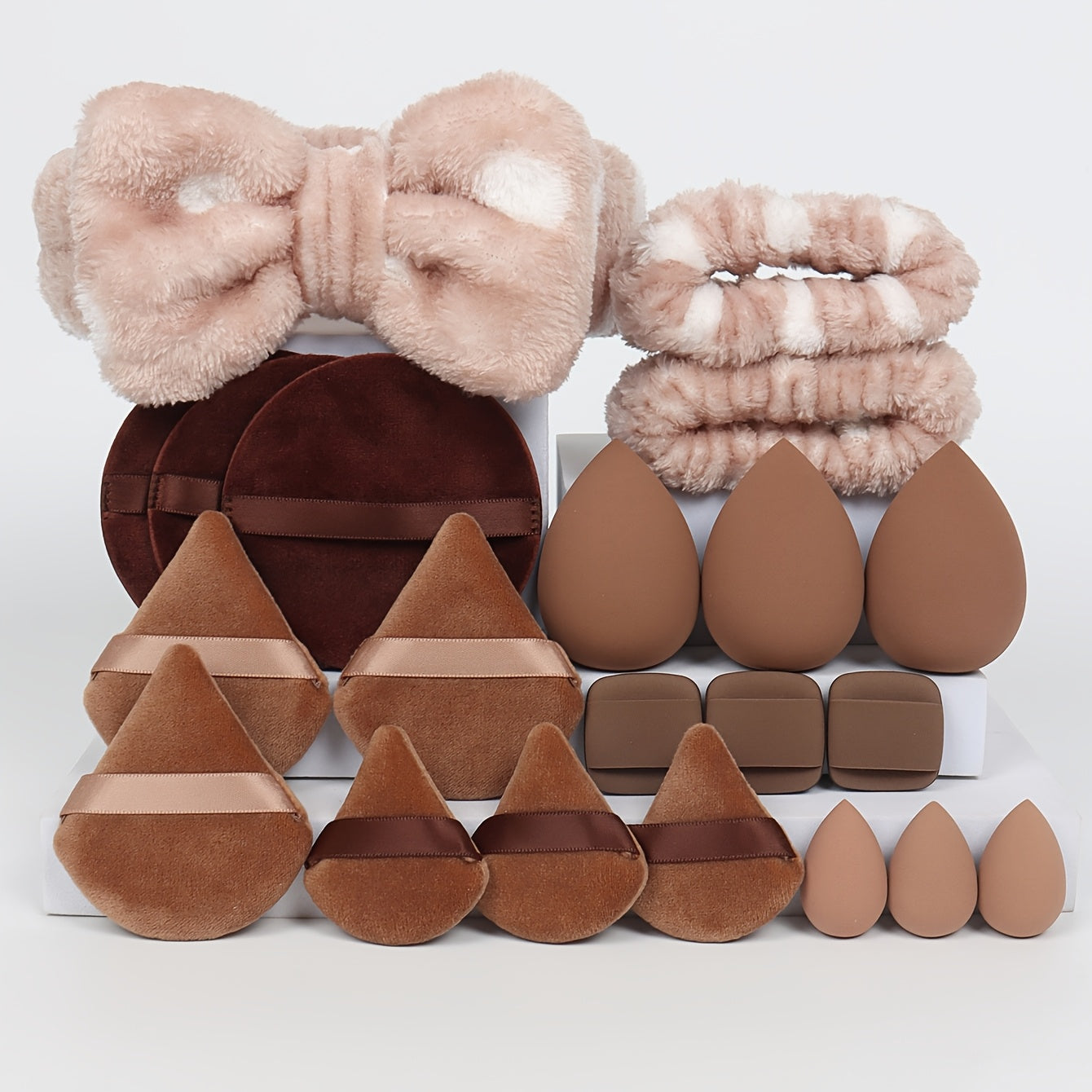 A Set of 21 Hair Accessories, Including 1 Butterfly Headband, 2 Wristbands, 6 Powder Puffs, 3 Makeup Sponges, 3 Finger Cushions, 3 Makeup Remover Pads, And 3 Mini Beauty Sponges.