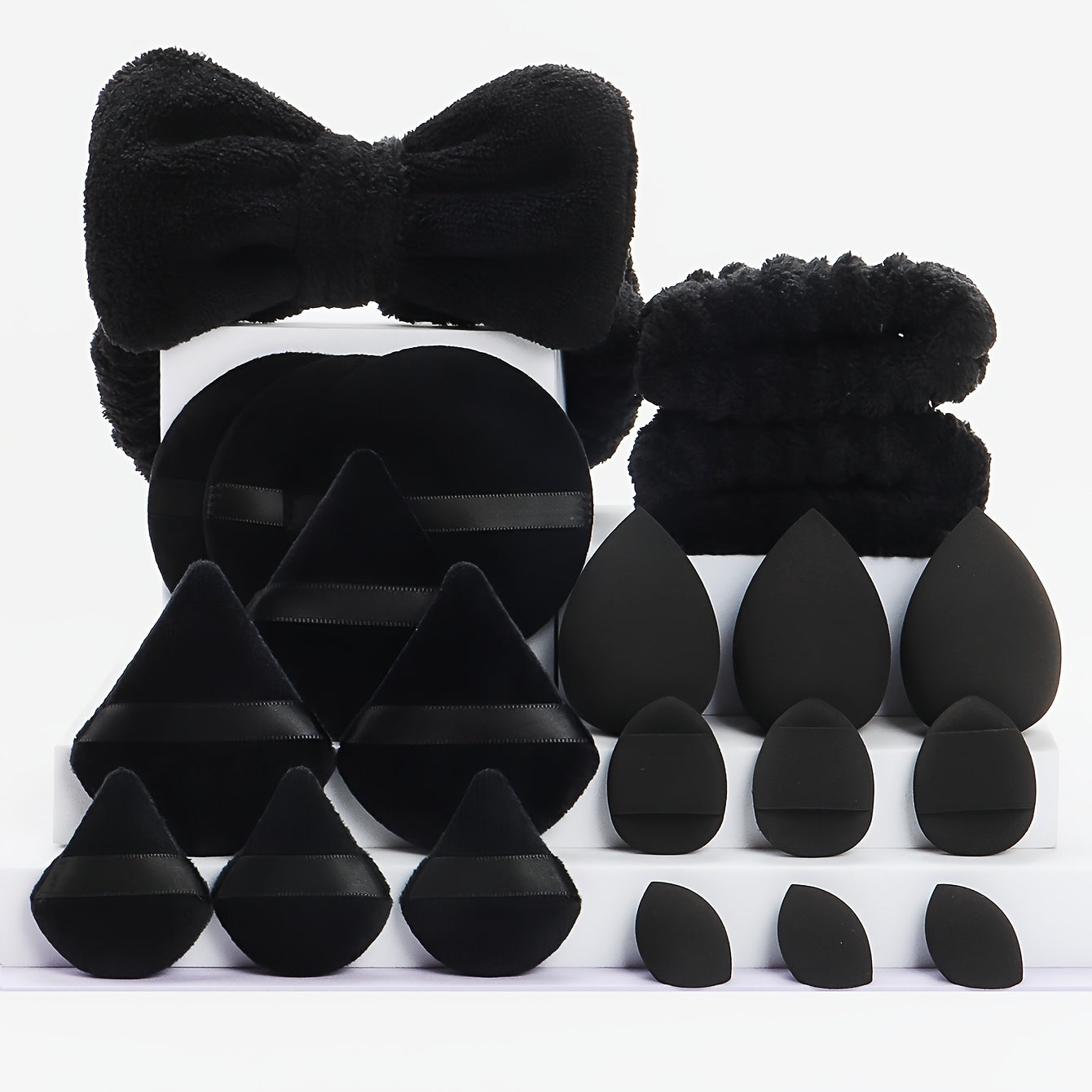 A Set of 21 Hair Accessories, Including 1 Butterfly Headband, 2 Wristbands, 6 Powder Puffs, 3 Makeup Sponges, 3 Finger Cushions, 3 Makeup Remover Pads, And 3 Mini Beauty Sponges.
