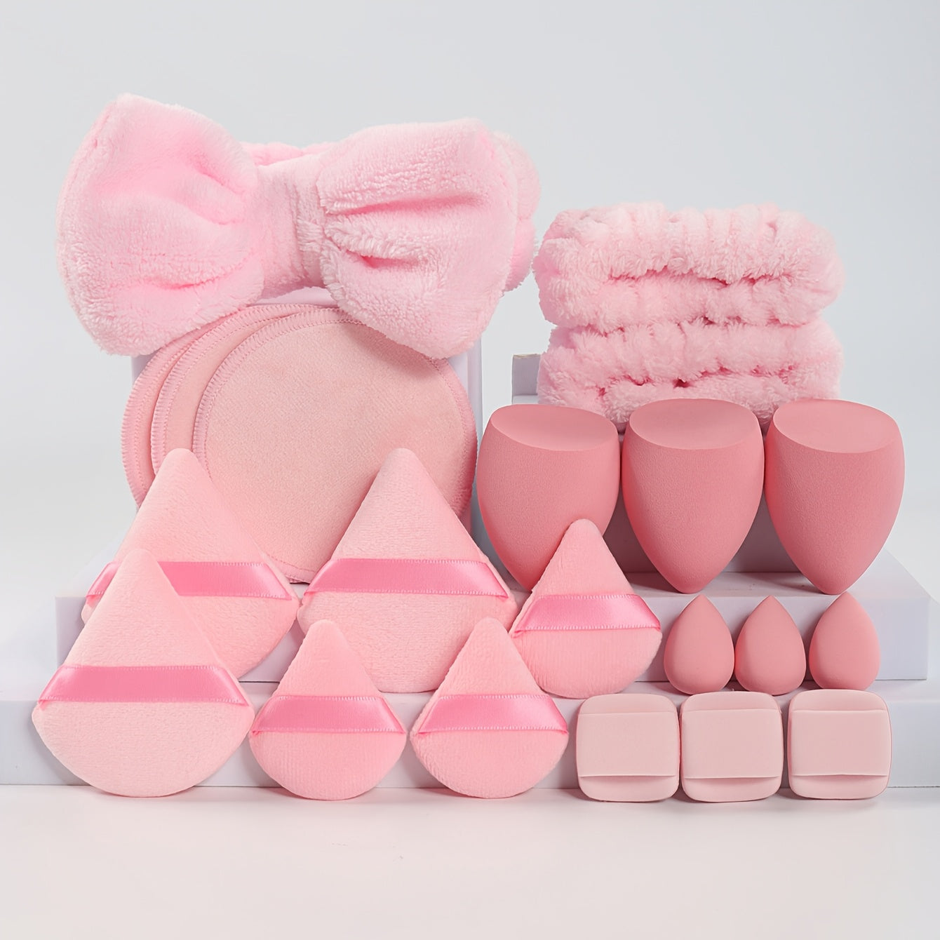 A Set of 21 Hair Accessories, Including 1 Butterfly Headband, 2 Wristbands, 6 Powder Puffs, 3 Makeup Sponges, 3 Finger Cushions, 3 Makeup Remover Pads, And 3 Mini Beauty Sponges.