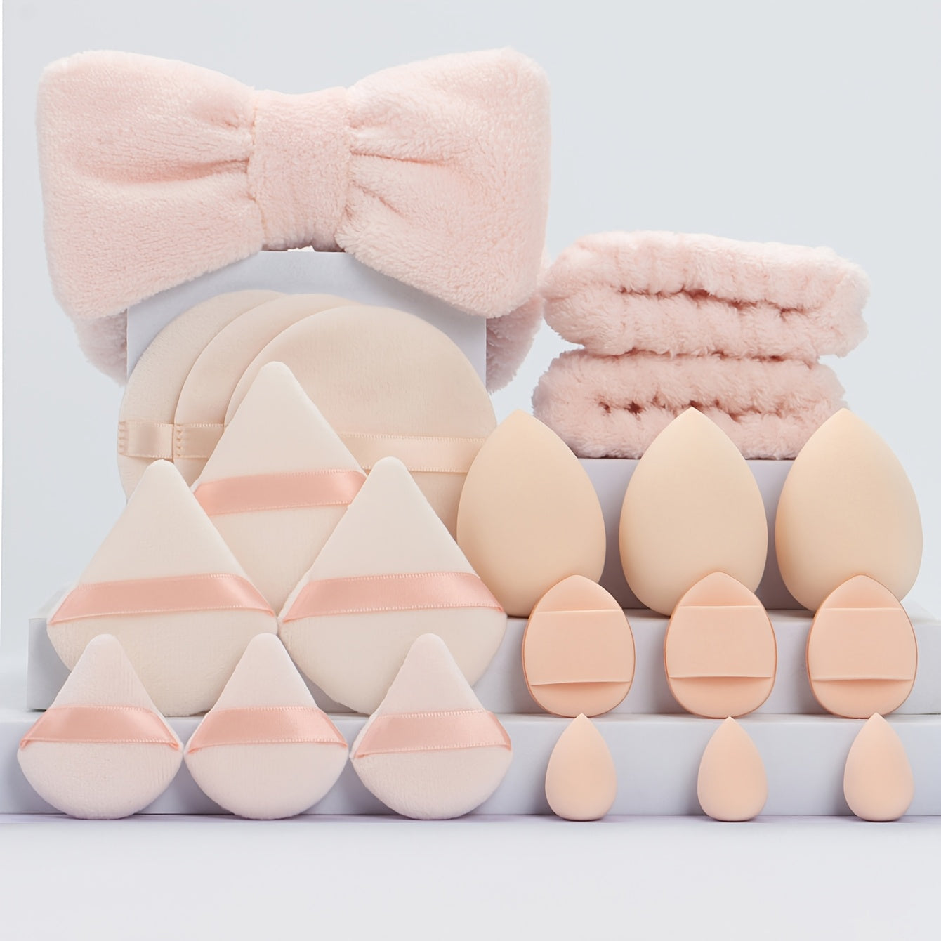 A Set of 21 Hair Accessories, Including 1 Butterfly Headband, 2 Wristbands, 6 Powder Puffs, 3 Makeup Sponges, 3 Finger Cushions, 3 Makeup Remover Pads, And 3 Mini Beauty Sponges.